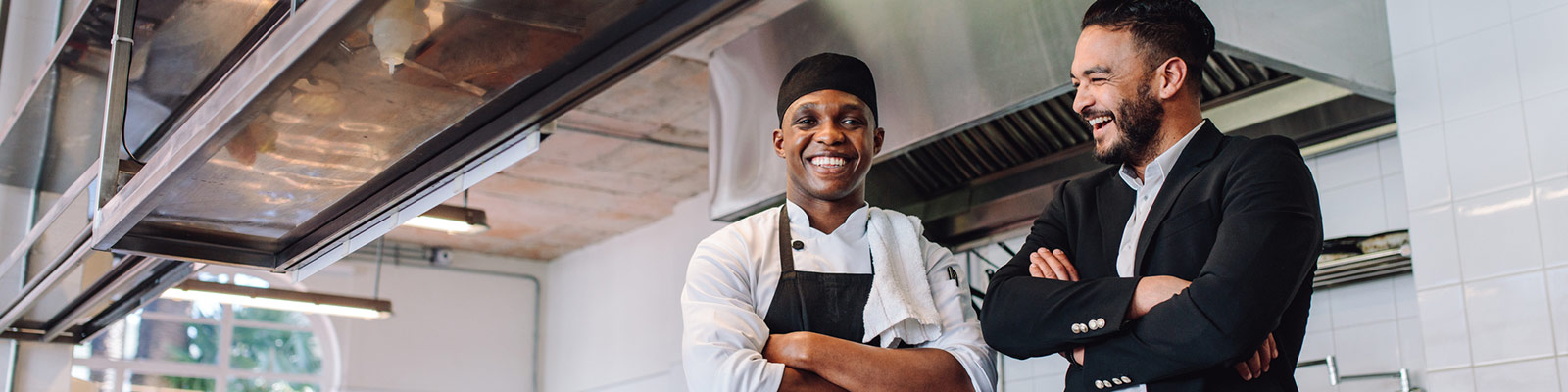 a chef and his manager smiling